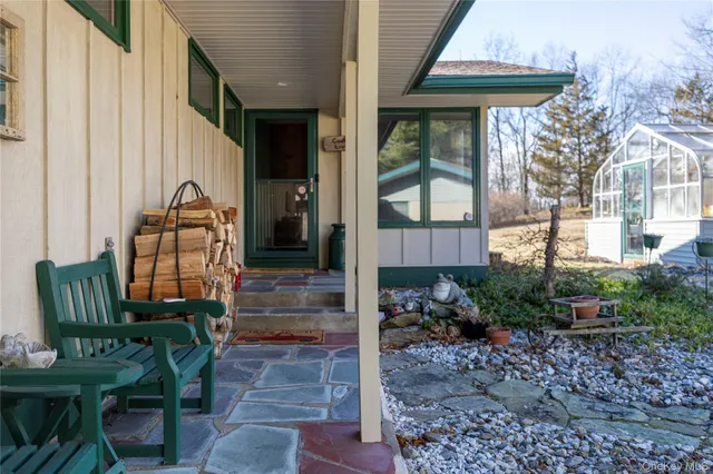 a view of a house with backyard and sitting area
