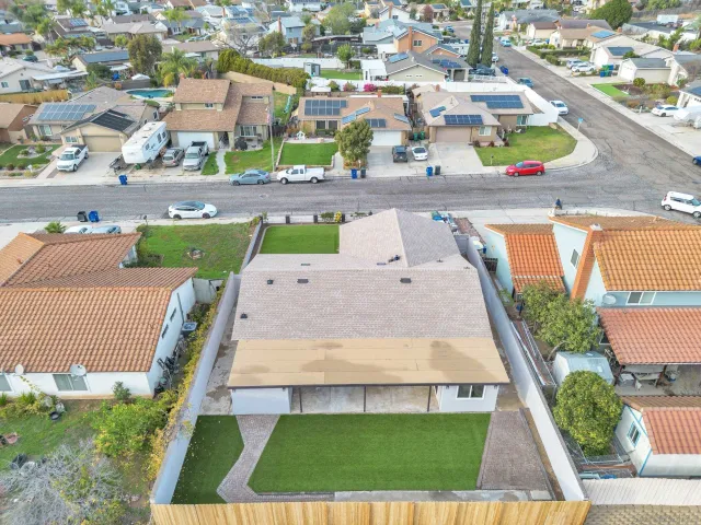 an aerial view of a house with a garden and deck