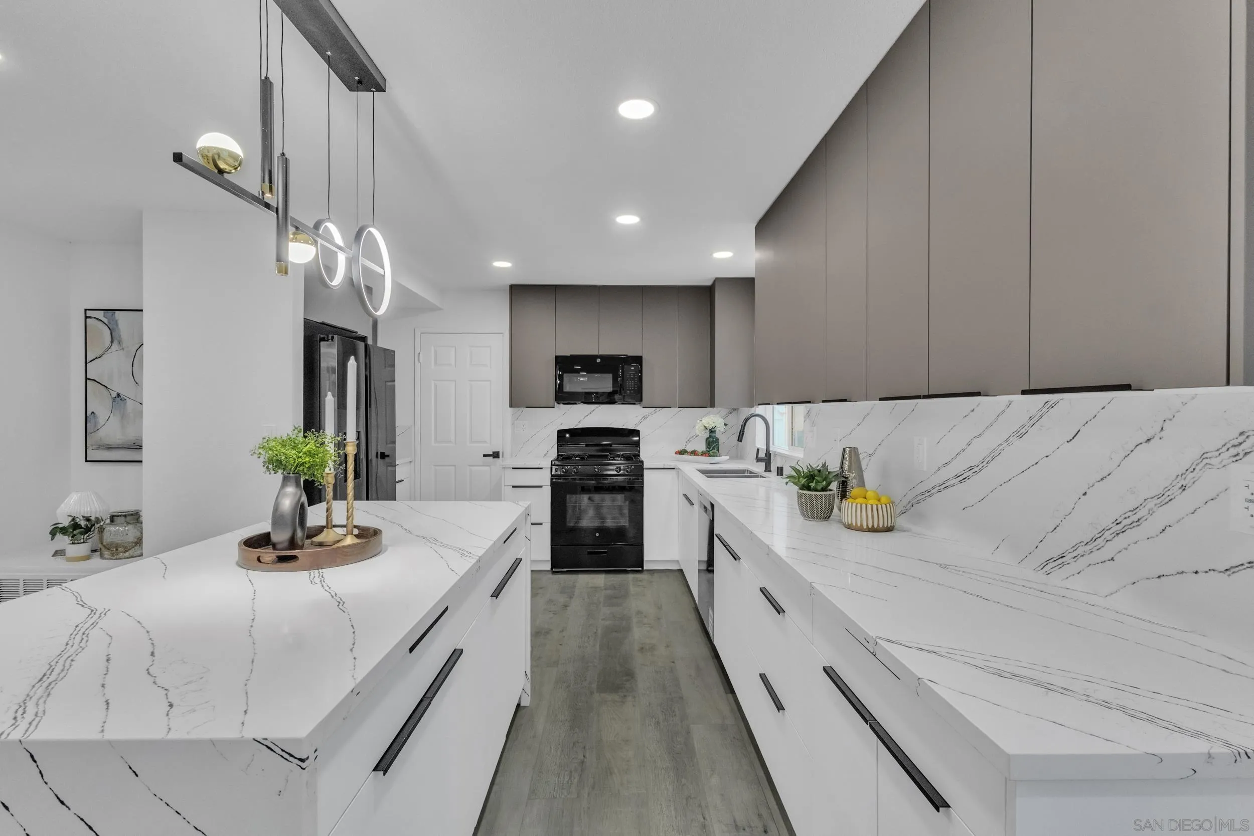 9253 Les Road Santee, CA 92071 - Photo 17 of 35 a kitchen with kitchen island granite countertop a sink cabinets and stainless steel appliances