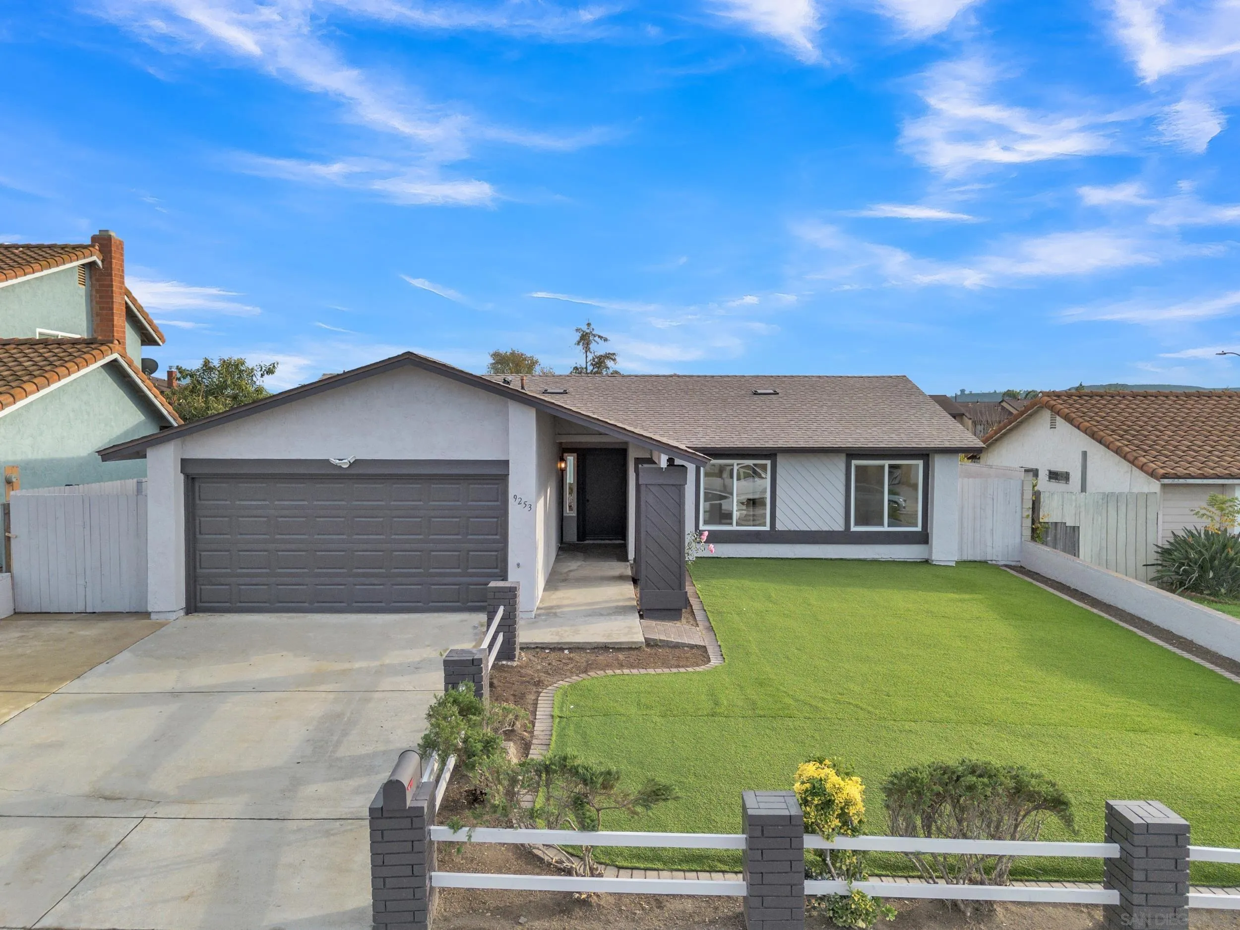 9253 Les Road Santee, CA 92071 - Photo 2 of 35 a front view of a house with garden