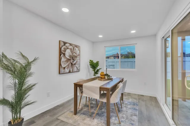 a view of a small space with wooden floor and a window