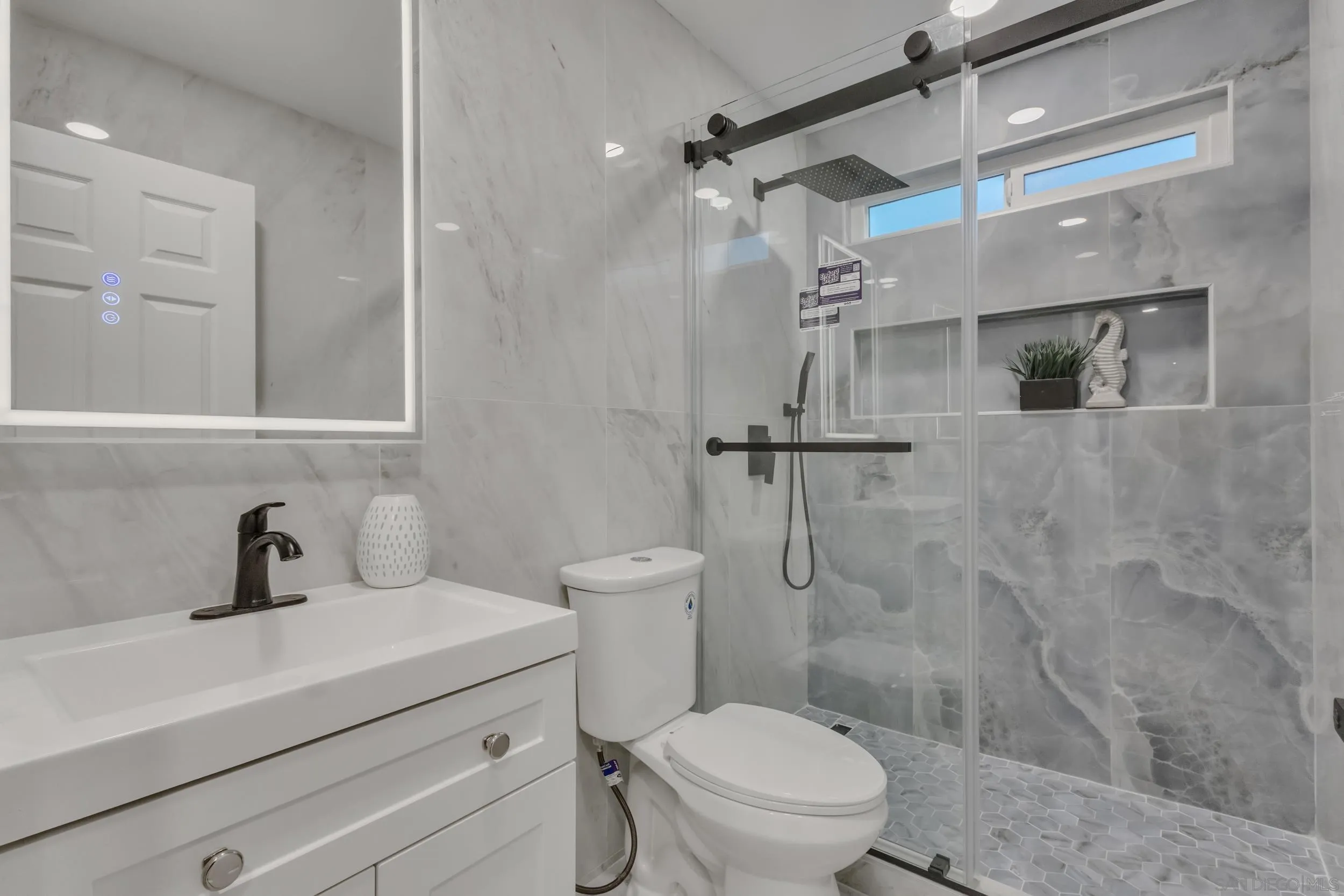 9253 Les Road Santee, CA 92071 - Photo 24 of 35 a bathroom with a sink a toilet and shower