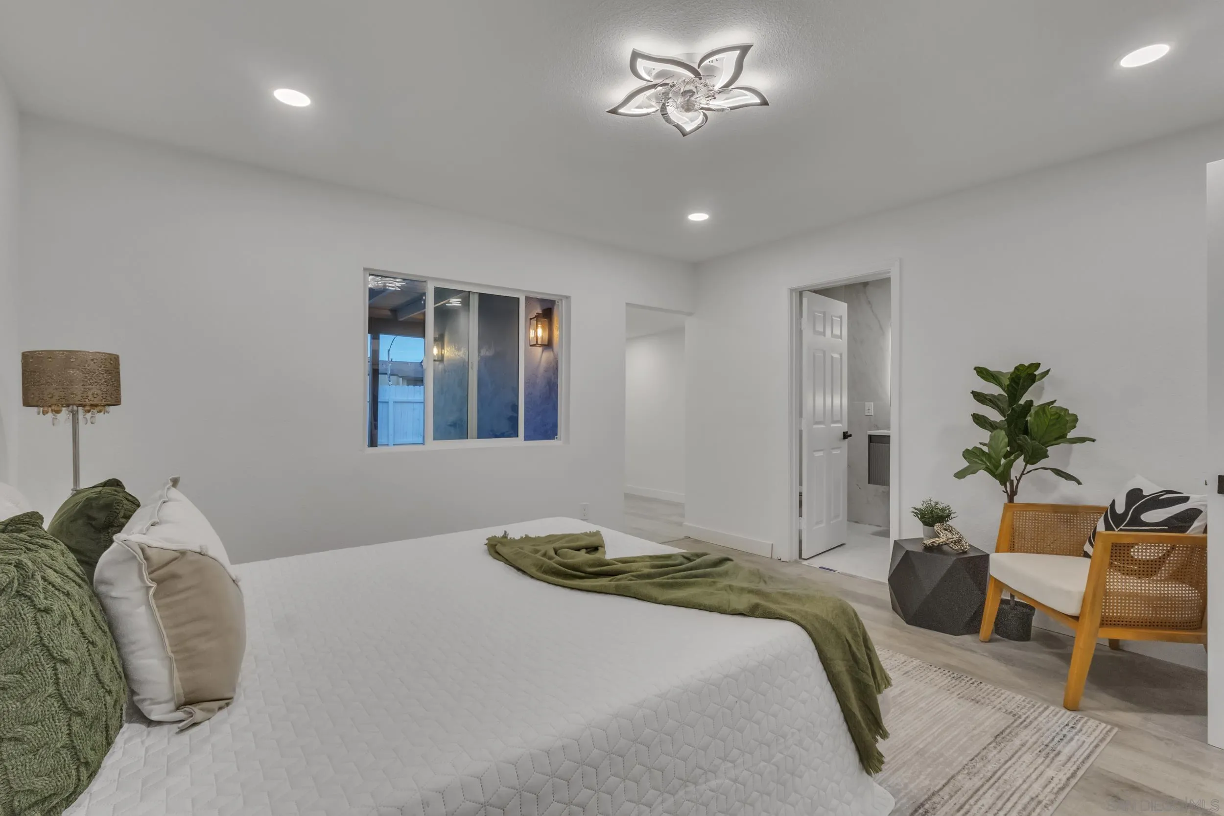 9253 Les Road Santee, CA 92071 - Photo 26 of 35 a bedroom with a bed and a chandelier