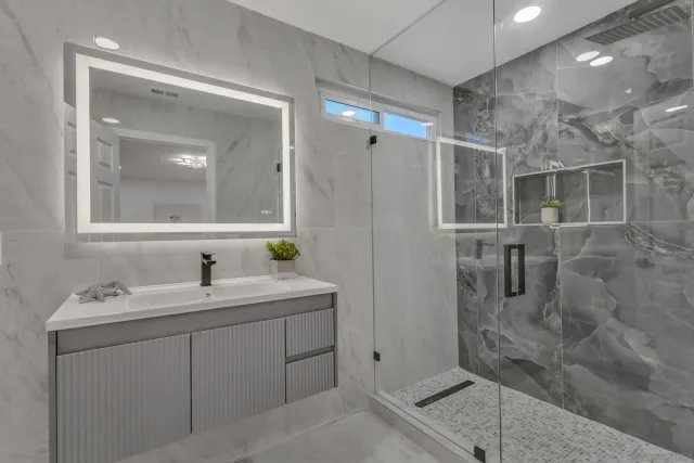 a bathroom with a toilet sink and mirror