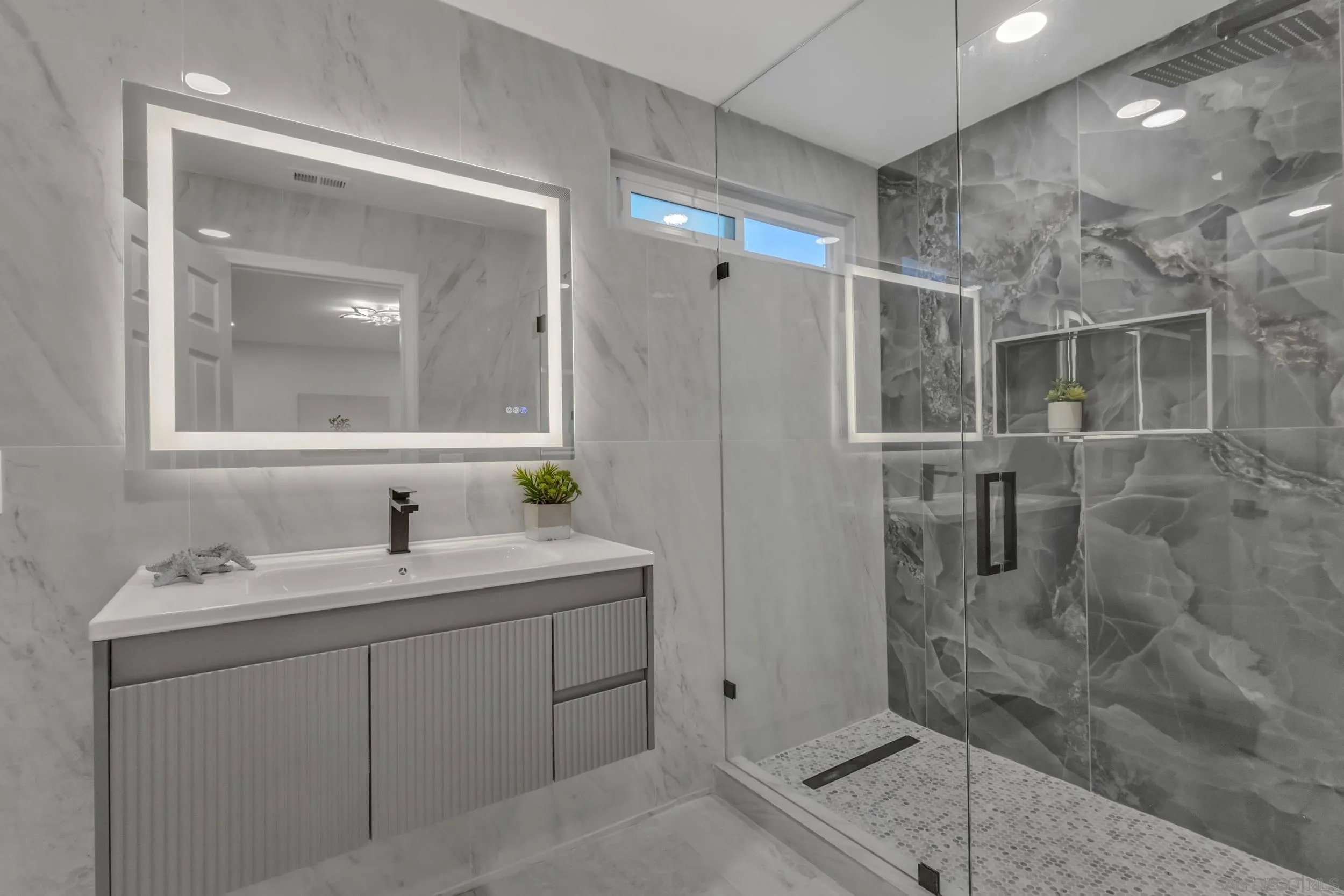 9253 Les Road Santee, CA 92071 - Photo 29 of 35 a bathroom with a shower sink and mirror