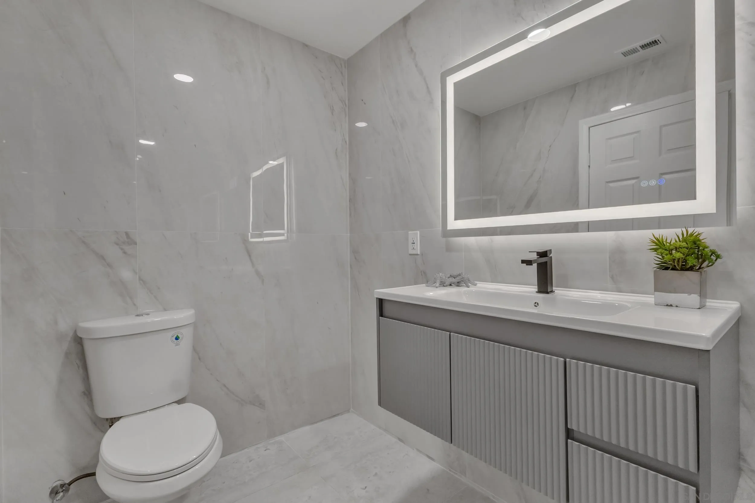 9253 Les Road Santee, CA 92071 - Photo 30 of 35 a bathroom with a toilet sink and mirror