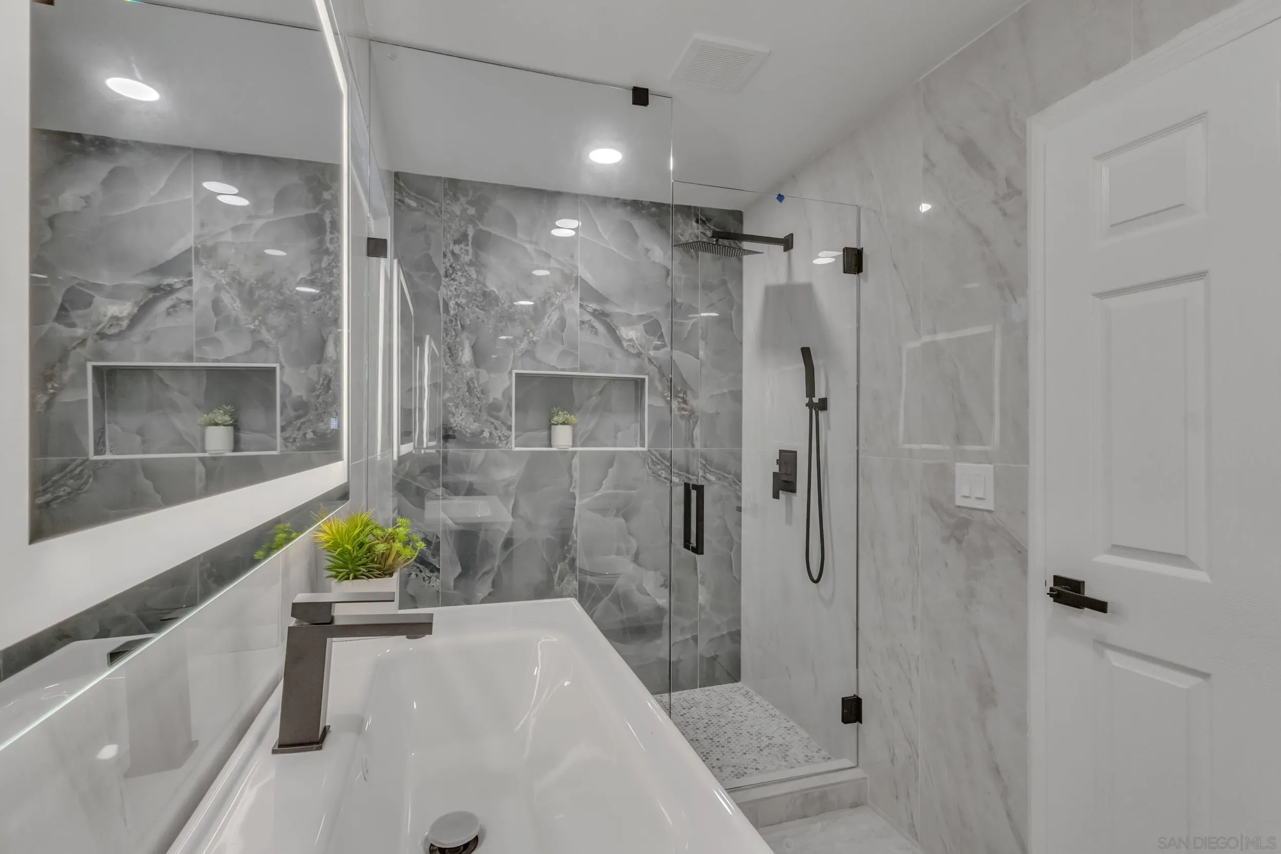 9253 Les Road Santee, CA 92071 - Photo 31 of 35 a bathroom with a bathtub shower sink and mirror