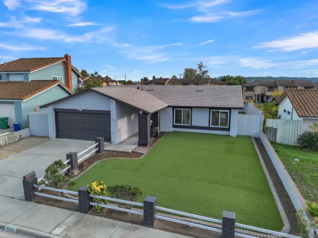 a view of a house with a yard