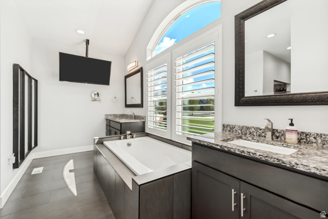 1526 South 500 West Mapleton, UT 84664 - Photo 11 of 54 Full bathroom with a garden tub, lofted ceiling, two vanities, and recessed lighting