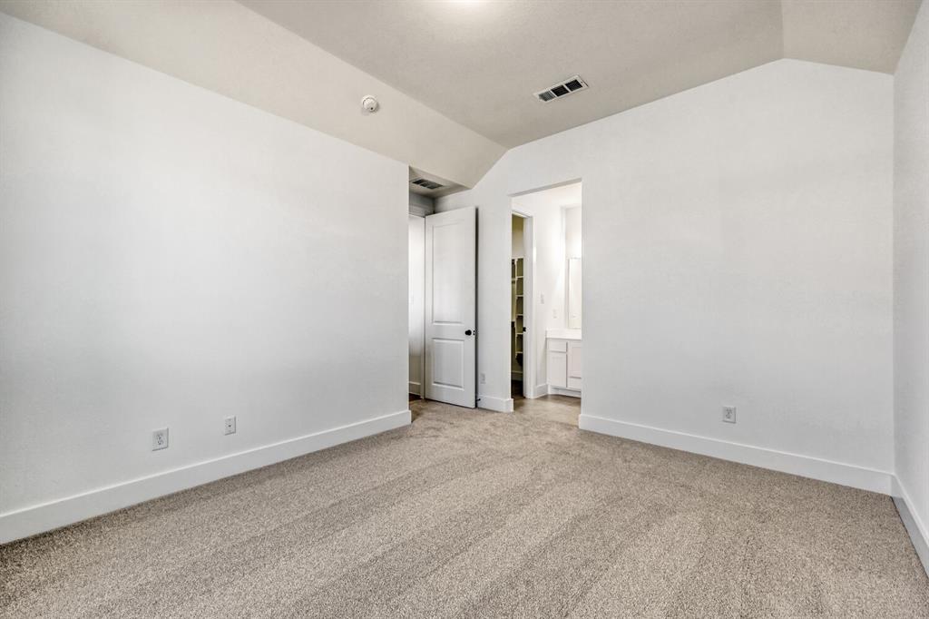 147 Derrett Lane Rhome, TX 76078 - Photo 12 of 28 Unfurnished bedroom with light colored carpet and connected bathroom