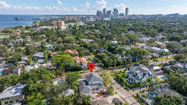 an aerial view of residential house with outdoor space and trees all around