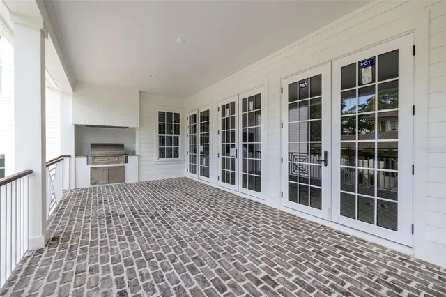 a view of a balcony with wooden floor and windows