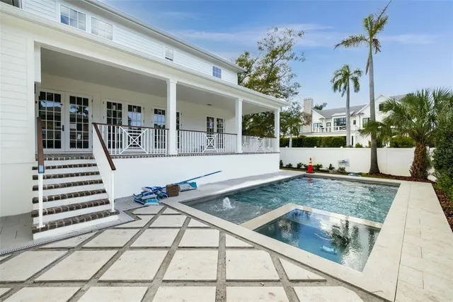 a view of a swimming pool with potted plants