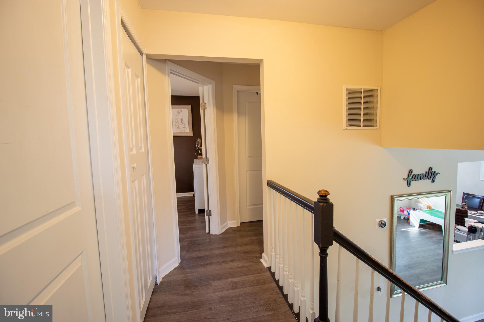 18907 Barnette Circle Triangle, VA 22172 - Photo 13 of 39 a view of a hallway with wooden floor and stairs