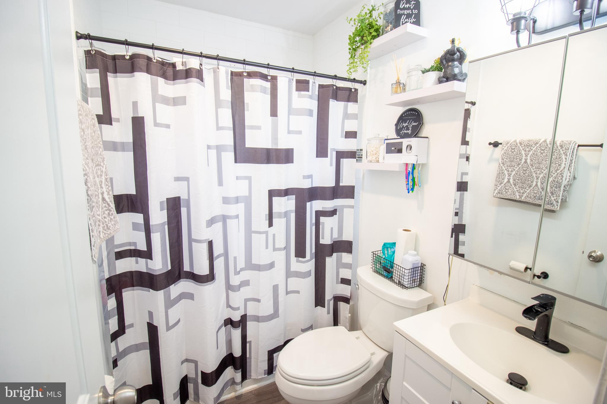 18907 Barnette Circle Triangle, VA 22172 - Photo 16 of 39 a bathroom with a sink vanity mirror and toilet