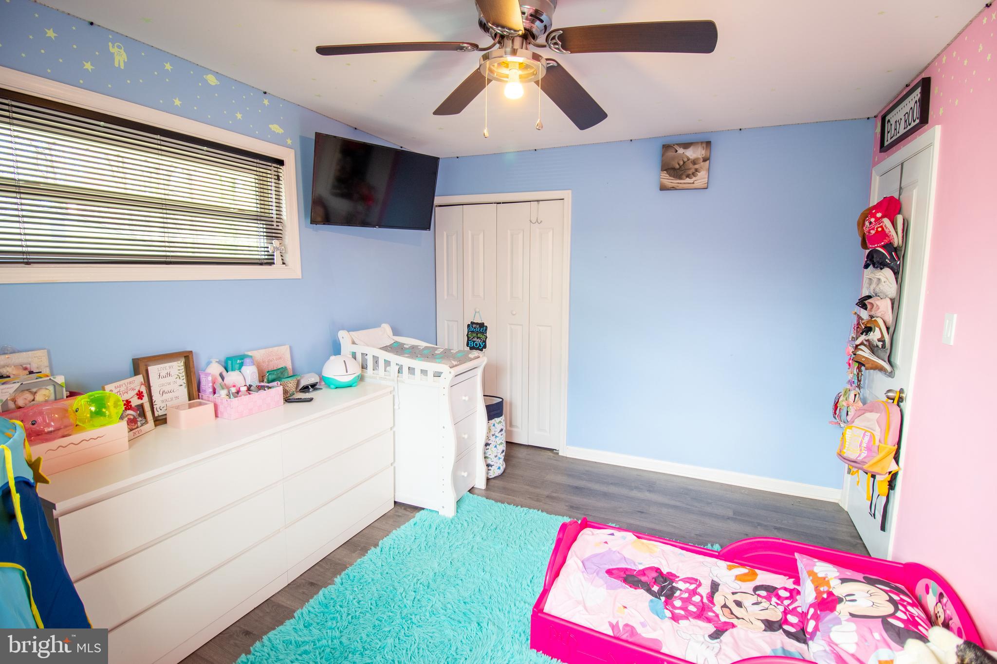 18907 Barnette Circle Triangle, VA 22172 - Photo 19 of 39 a bedroom with a bed and a chandelier