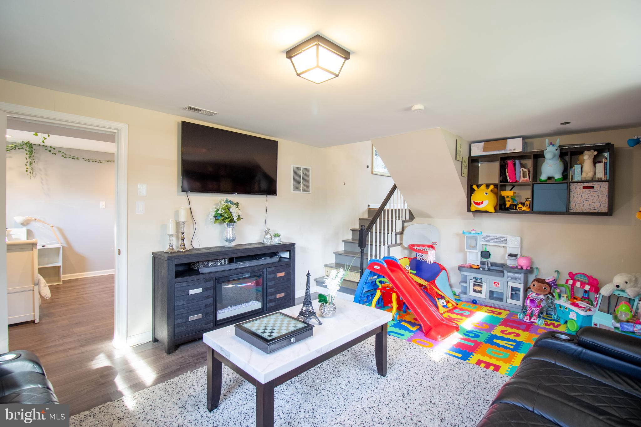 18907 Barnette Circle Triangle, VA 22172 - Photo 22 of 39 a living room with furniture and a flat screen tv