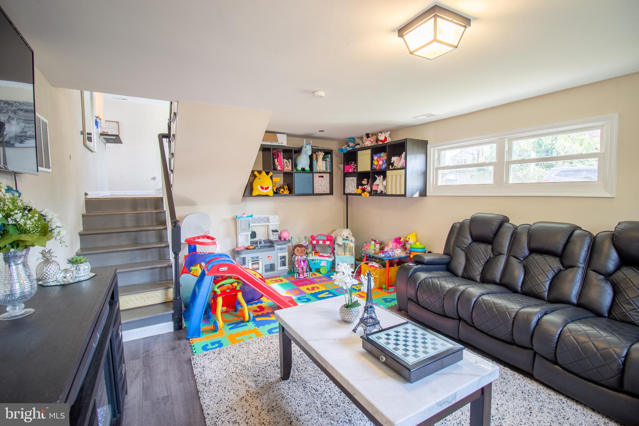 18907 Barnette Circle Triangle, VA 22172 - Photo 23 of 39 a living room with furniture and a book shelf