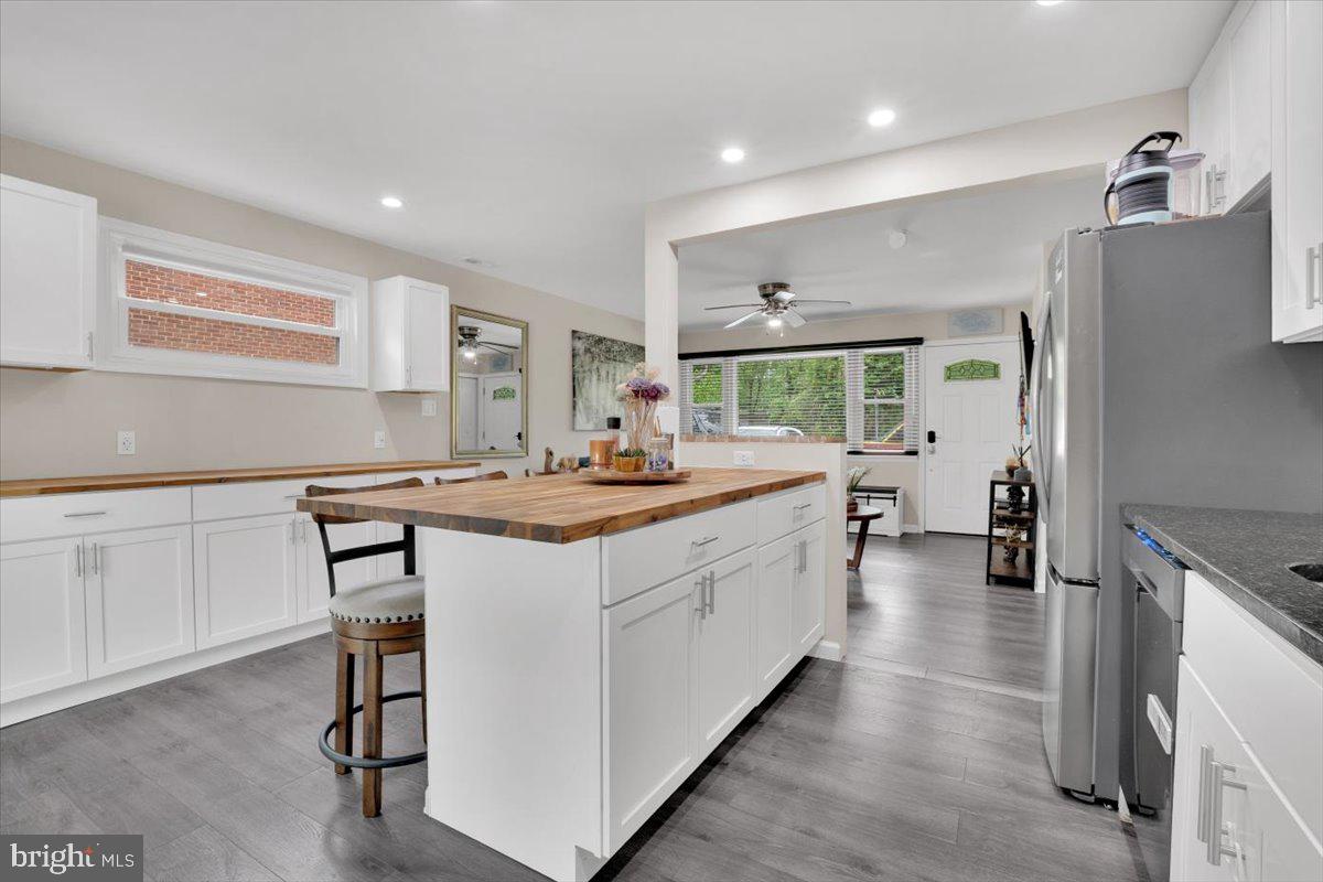 18907 Barnette Circle Triangle, VA 22172 - Photo 7 of 39 a kitchen with a sink refrigerator and chairs