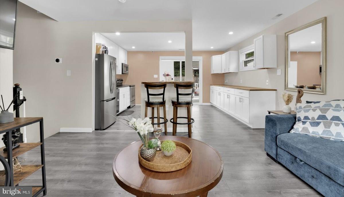 18907 Barnette Circle Triangle, VA 22172 - Photo 10 of 39 a living room with furniture and a dining table