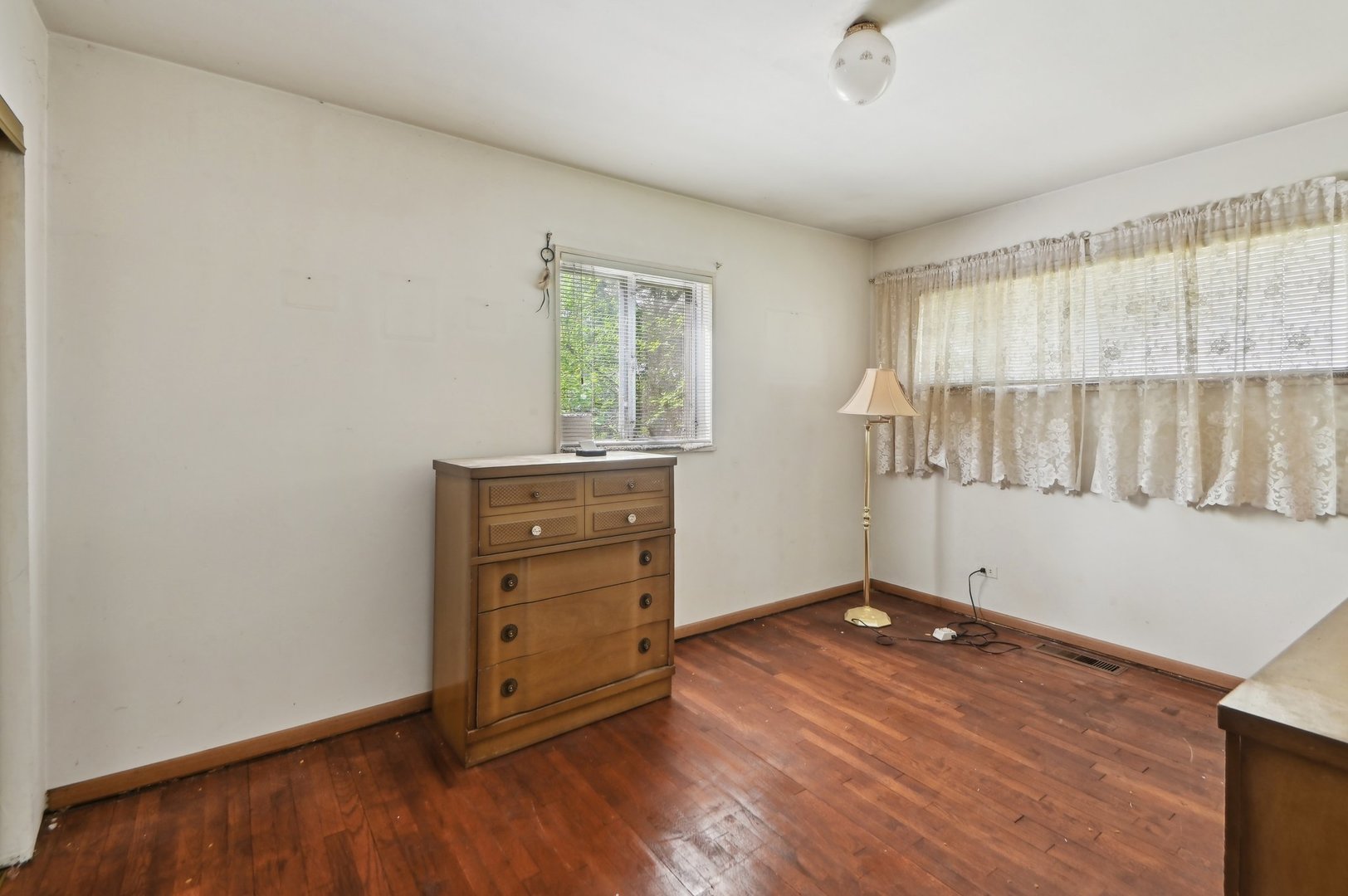 225 Bode Road Hoffman Estates, IL 60169 - Photo 12 of 26 an empty room with wooden floor cabinet and windows