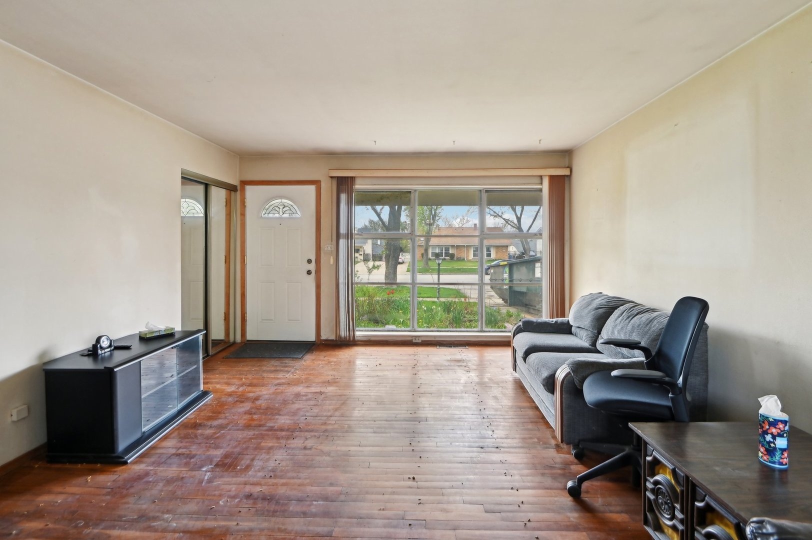 225 Bode Road Hoffman Estates, IL 60169 - Photo 3 of 26 a living room with furniture rug and a window