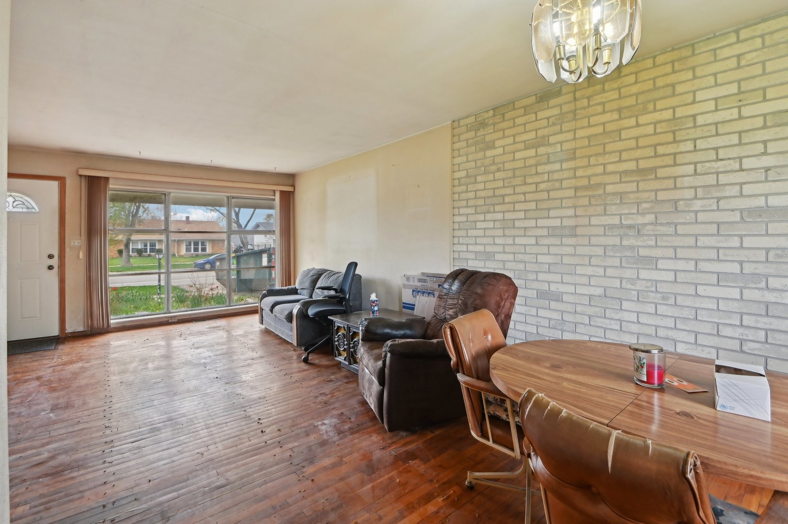 225 Bode Road Hoffman Estates, IL 60169 - Photo 6 of 26 a view of a dining room with furniture a chandelier and wooden floor