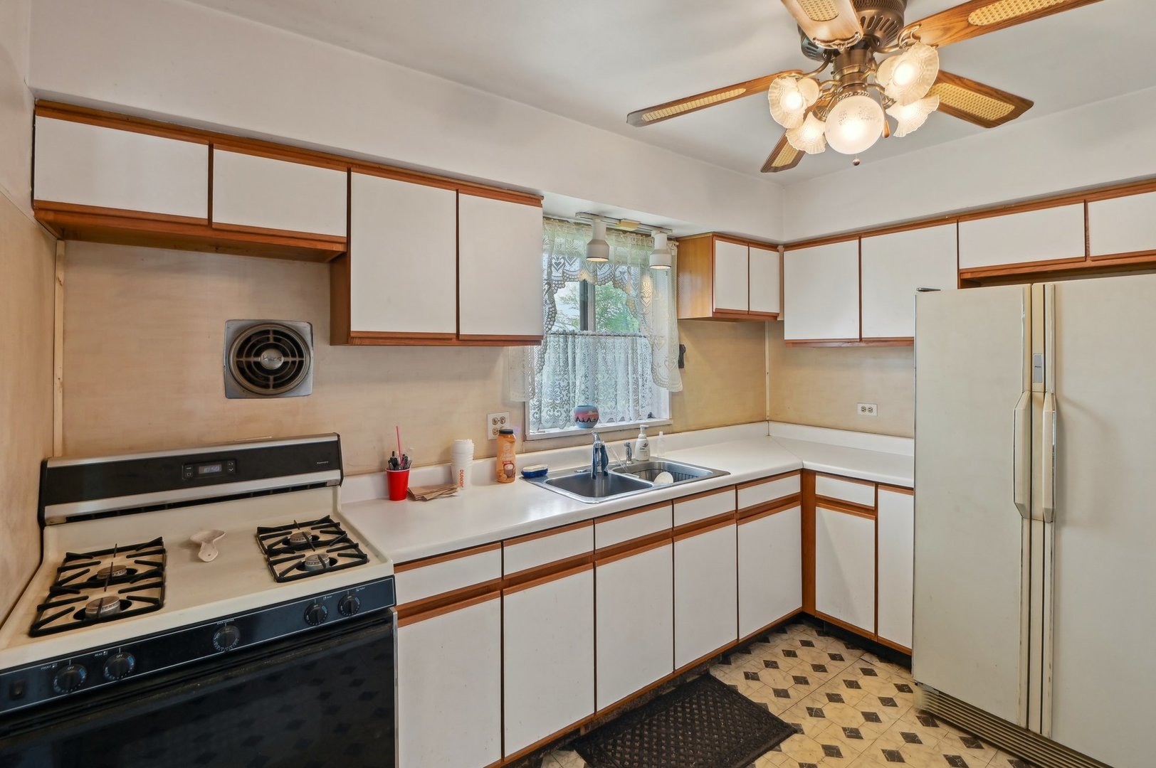 225 Bode Road Hoffman Estates, IL 60169 - Photo 10 of 26 a kitchen with stainless steel appliances a stove a sink and a refrigerator