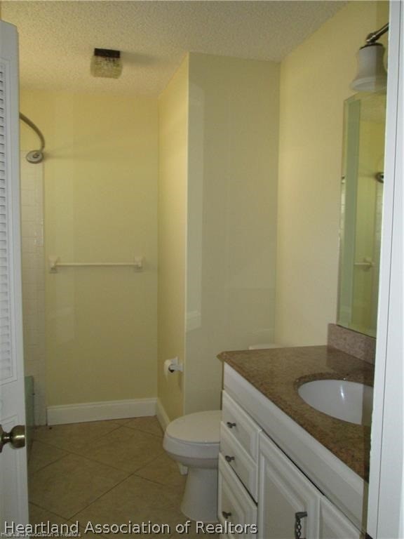 3062 Orchid Road Lake Placid, FL 33852 - Photo 3 of 11 a bathroom with a granite countertop toilet and a sink
