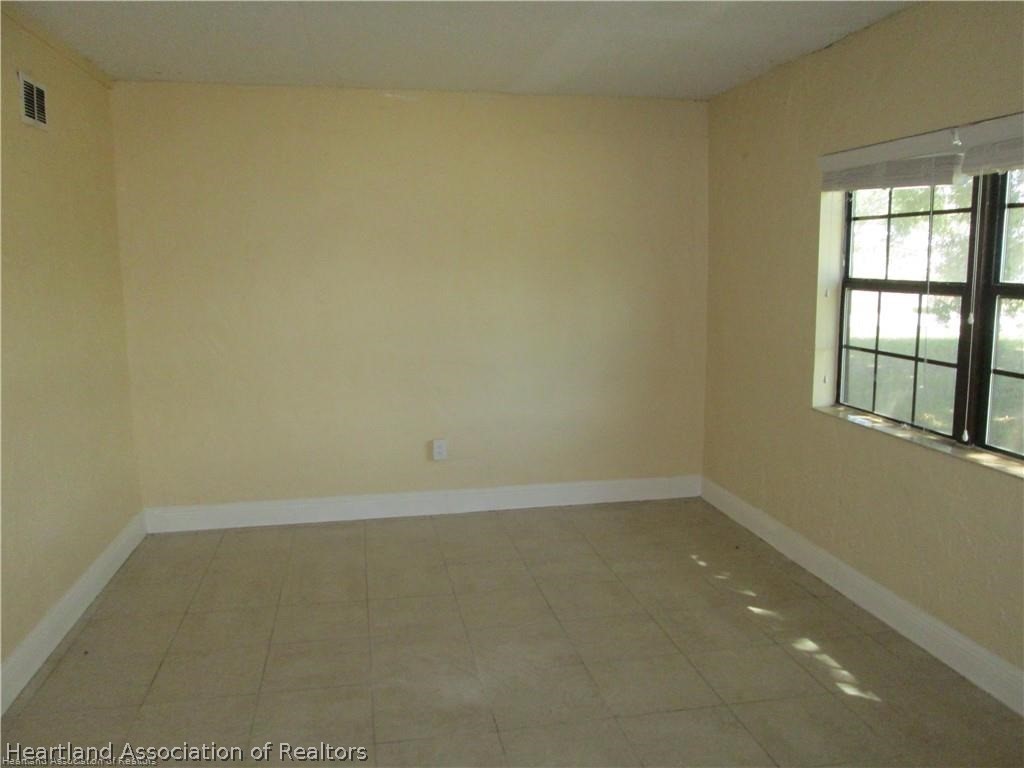 3062 Orchid Road Lake Placid, FL 33852 - Photo 10 of 11 an empty room with a empty space and window