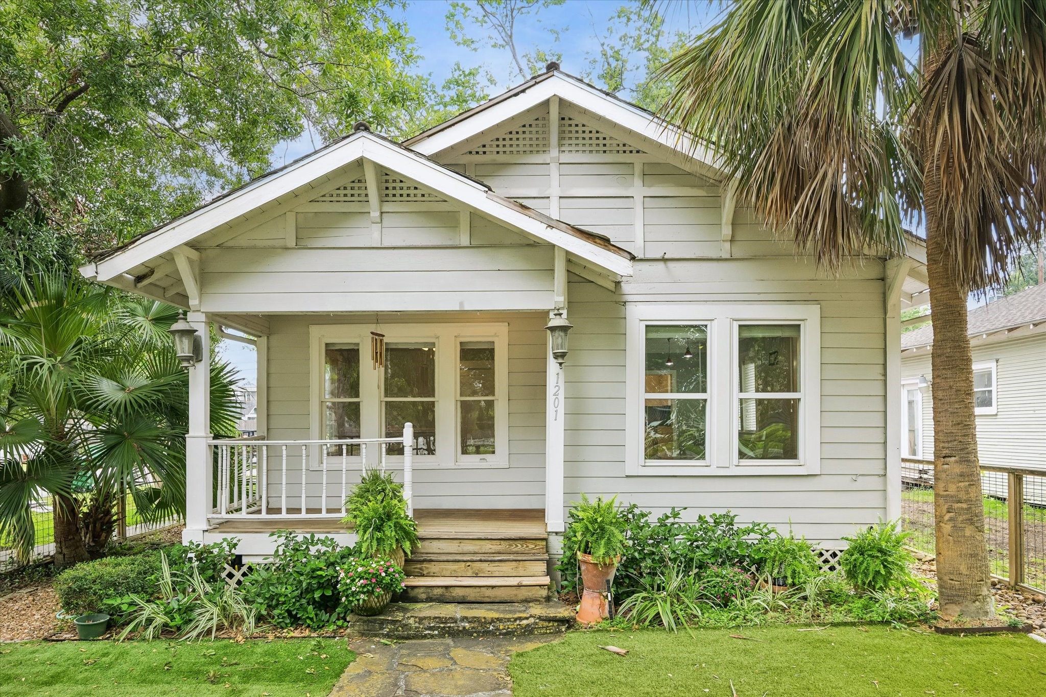 1201 Tulane Street Houston, TX 77008 - Photo 2 of 31 Built in 1930, this charming 2-bedroom, 1-bath Heights cottage sits on a fully fenced corner lot with a gated driveway and covered carport. Inside, the home gets even better with beautiful hardwood floors, rich millwork, oversized windows, and thoughtfully updated kitchen and bathroom, making this classic home a true standout.