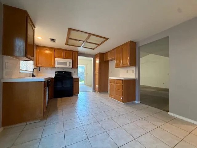 a kitchen with stainless steel appliances a refrigerator and a stove