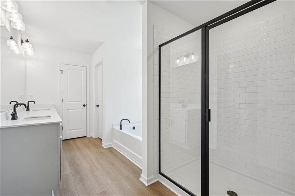 308 Silverleaf Trail Bethlehem, GA 30620 - Photo 18 of 36 a bathroom with a tub a sink and mirror