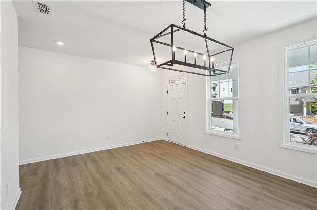 308 Silverleaf Trail Bethlehem, GA 30620 - Photo 3 of 36 a view of a room with wooden floor and windows
