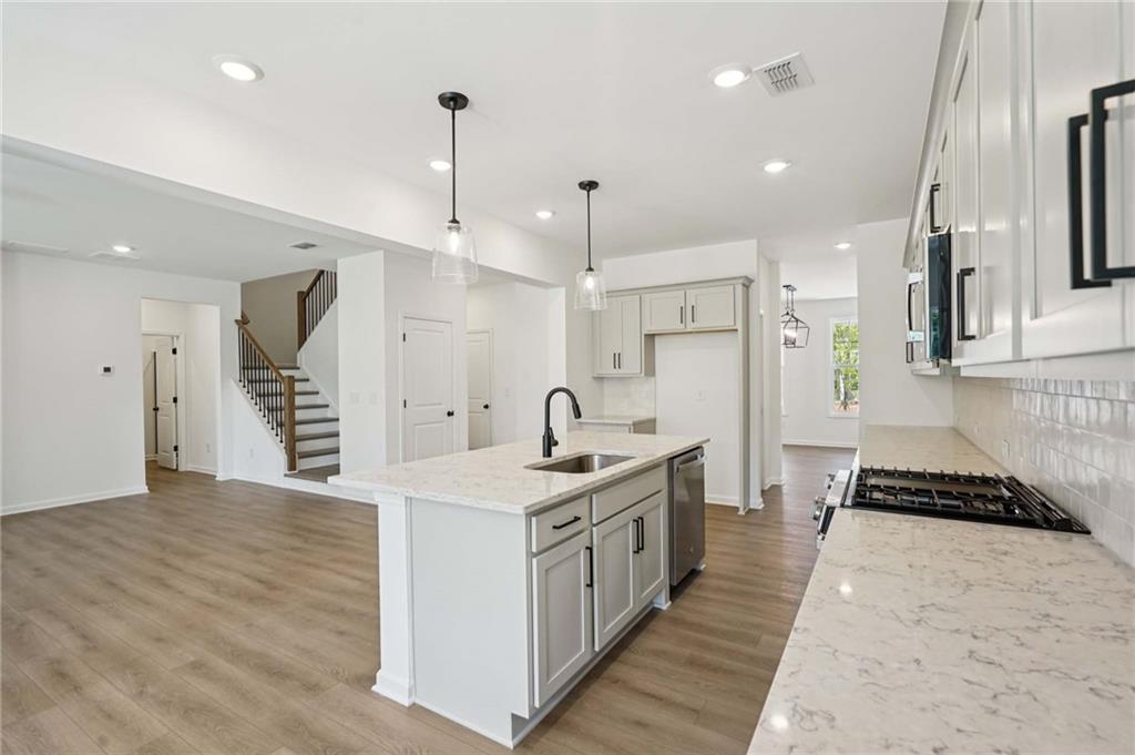 308 Silverleaf Trail Bethlehem, GA 30620 - Photo 7 of 36 a kitchen with stainless steel appliances kitchen island a refrigerator and a sink