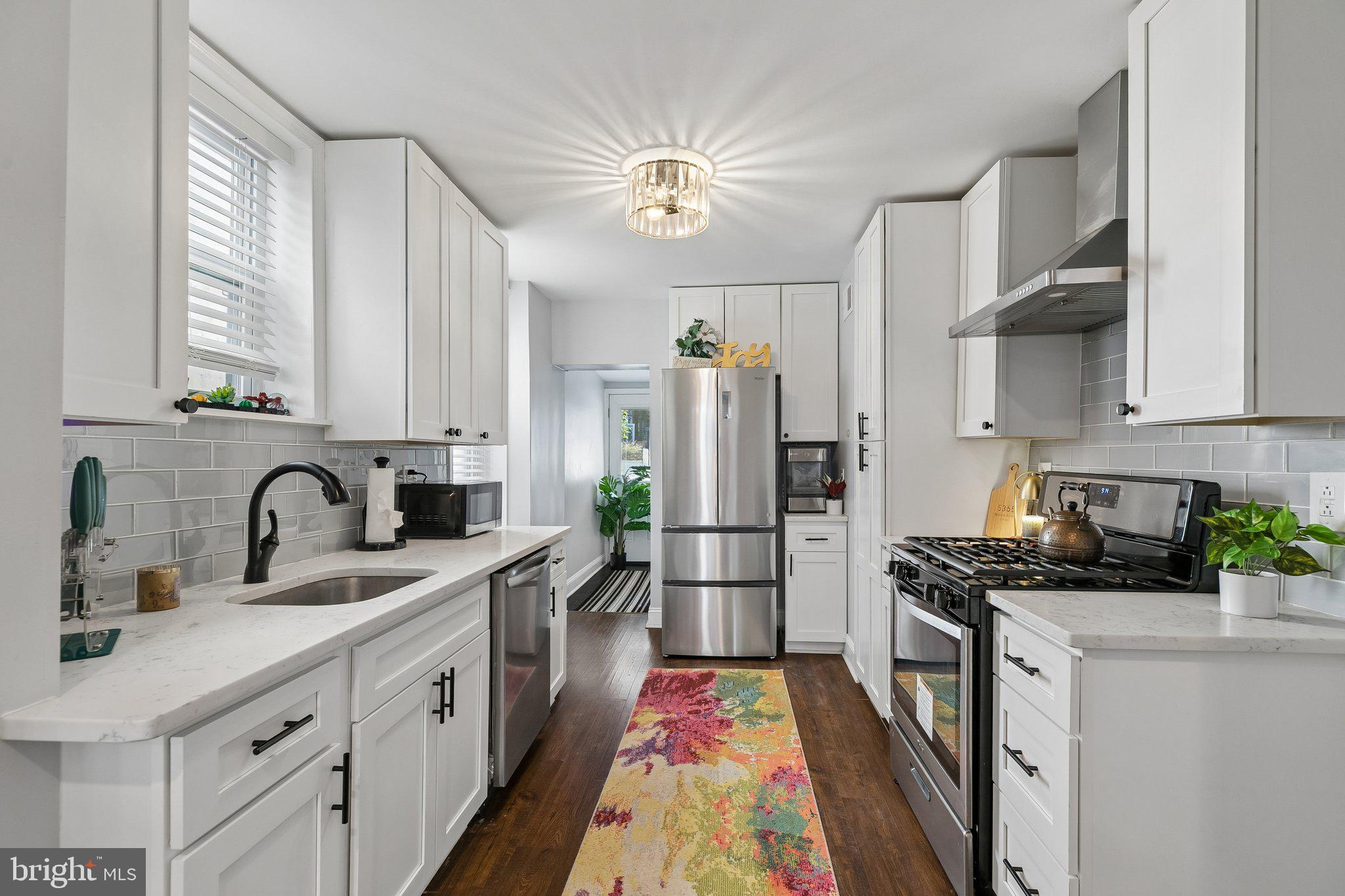 5365 Morris Street Philadelphia, PA 19144 - Photo 1 of 35 a kitchen with a refrigerator a sink dishwasher and a stove with wooden floor