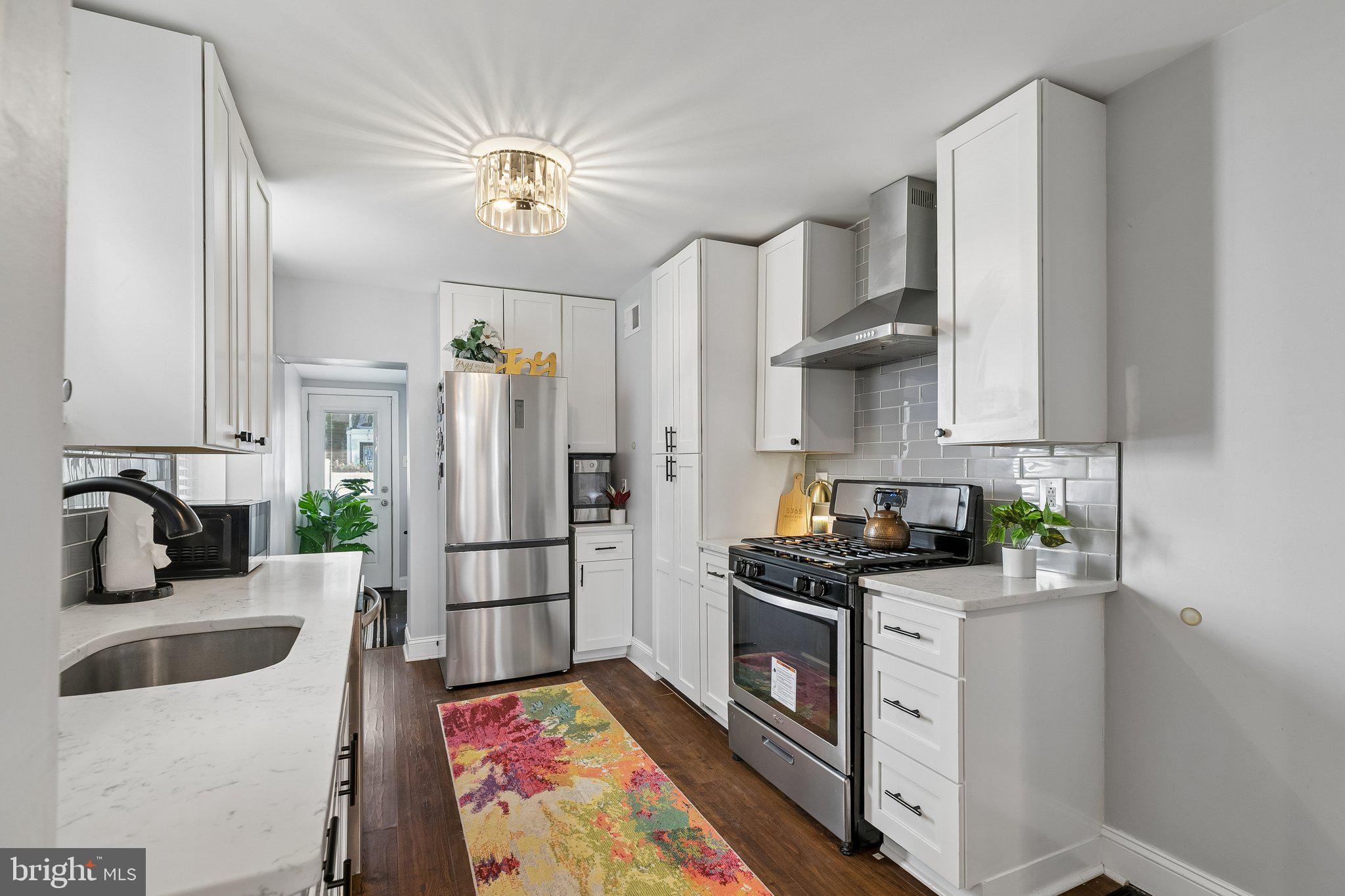 5365 Morris Street Philadelphia, PA 19144 - Photo 15 of 35 a kitchen with stainless steel appliances granite countertop a sink stove and refrigerator
