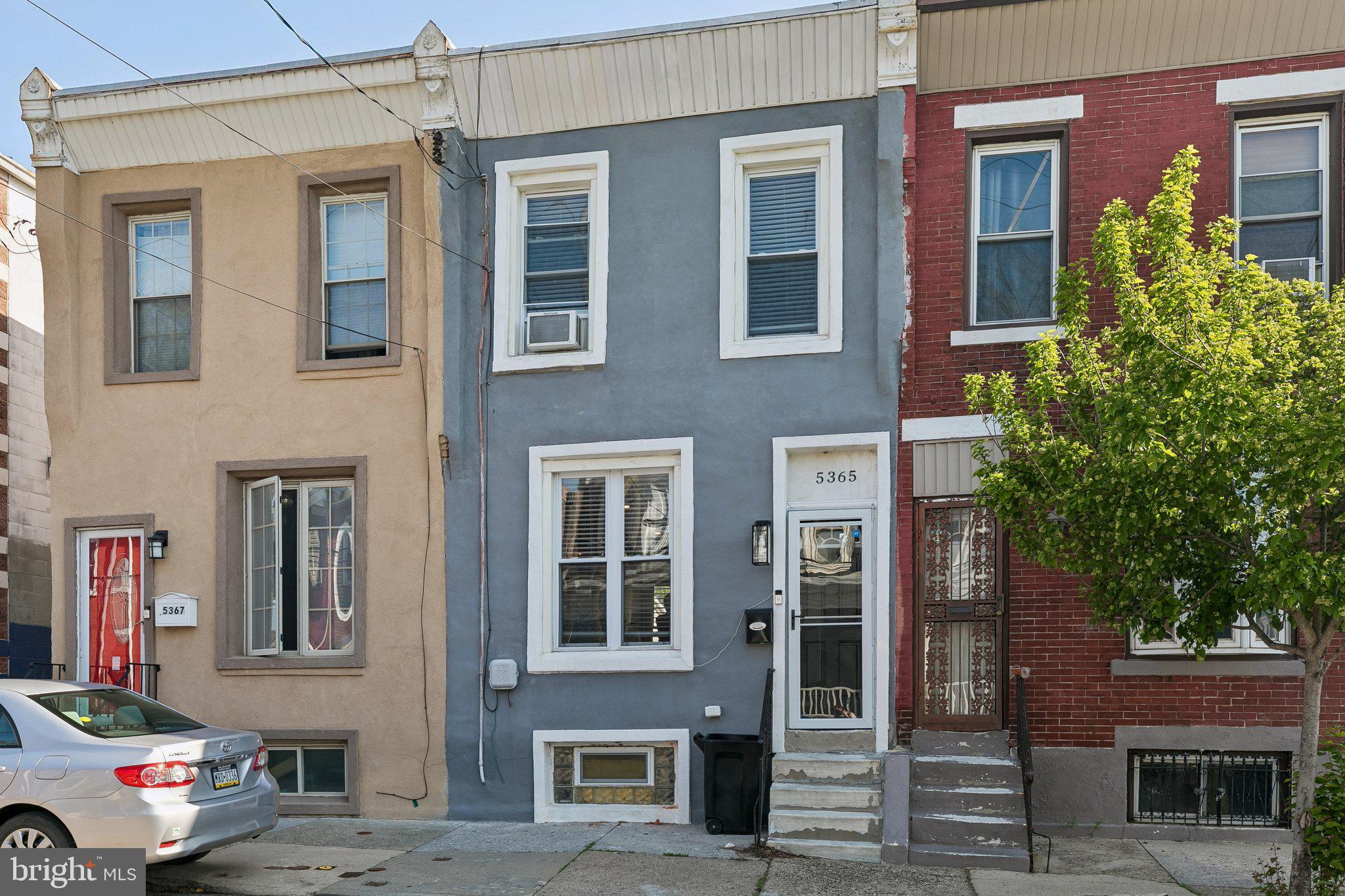 5365 Morris Street Philadelphia, PA 19144 - Photo 2 of 35 a store with couple of cars parked in front of house