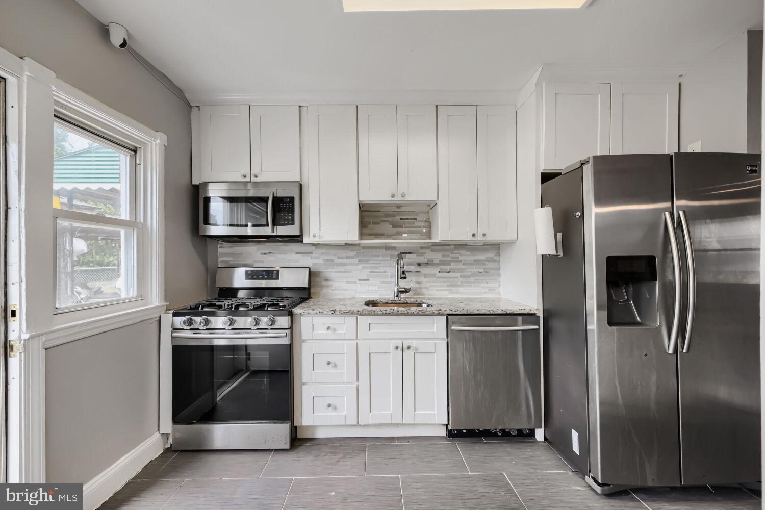 1014 Lyndhurst Street Baltimore, MD 21229 - Photo 1 of 29 a kitchen with a stove sink and refrigerator