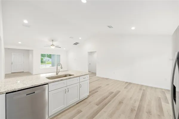 a spacious bathroom with a granite countertop sink and a mirror