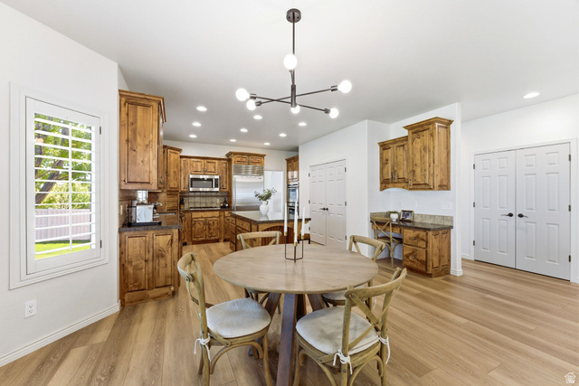 1712 Somerset Ridge Drive Draper, UT 84020 - Photo 23 of 76 Spacious kitchen and dining area featuring light wood-finish flooring, recessed lighting, and a modern chandelier