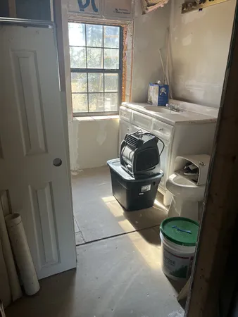 a living room with furniture and a toilet