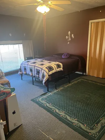 a bedroom with a bed and window