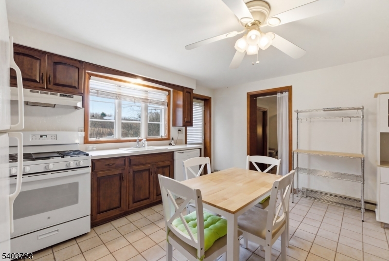 210 Highway 284 Wantage, NJ 07461 - Photo 14 of 28 a kitchen with a stove a sink and a refrigerator