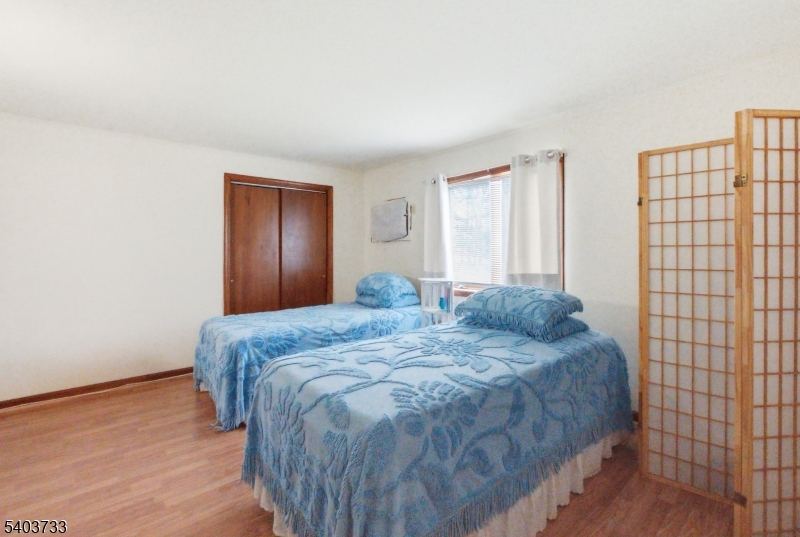 210 Highway 284 Wantage, NJ 07461 - Photo 16 of 28 a spacious bedroom with a bed and wooden floor