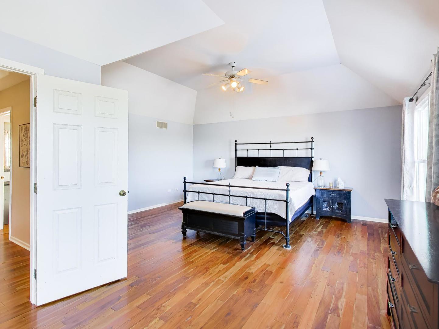 660 Robin Ridge Elgin, IL 60123 - Photo 14 of 29 a bedroom with a bed and wooden floor