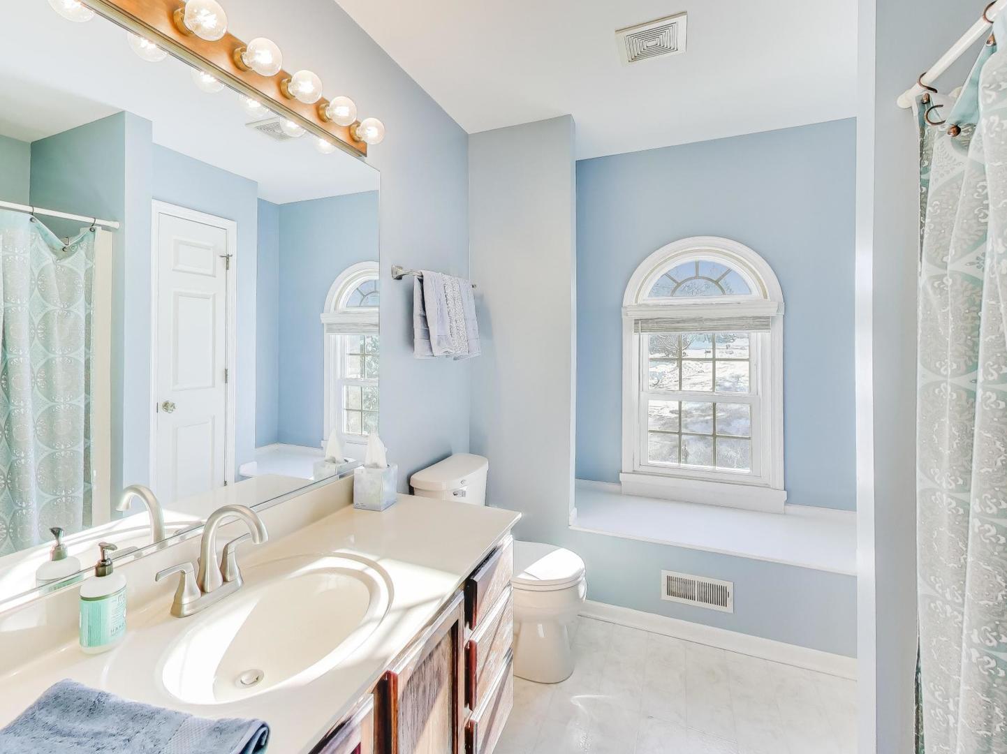 660 Robin Ridge Elgin, IL 60123 - Photo 20 of 29 a bathroom with a granite countertop sink a toilet and a mirror