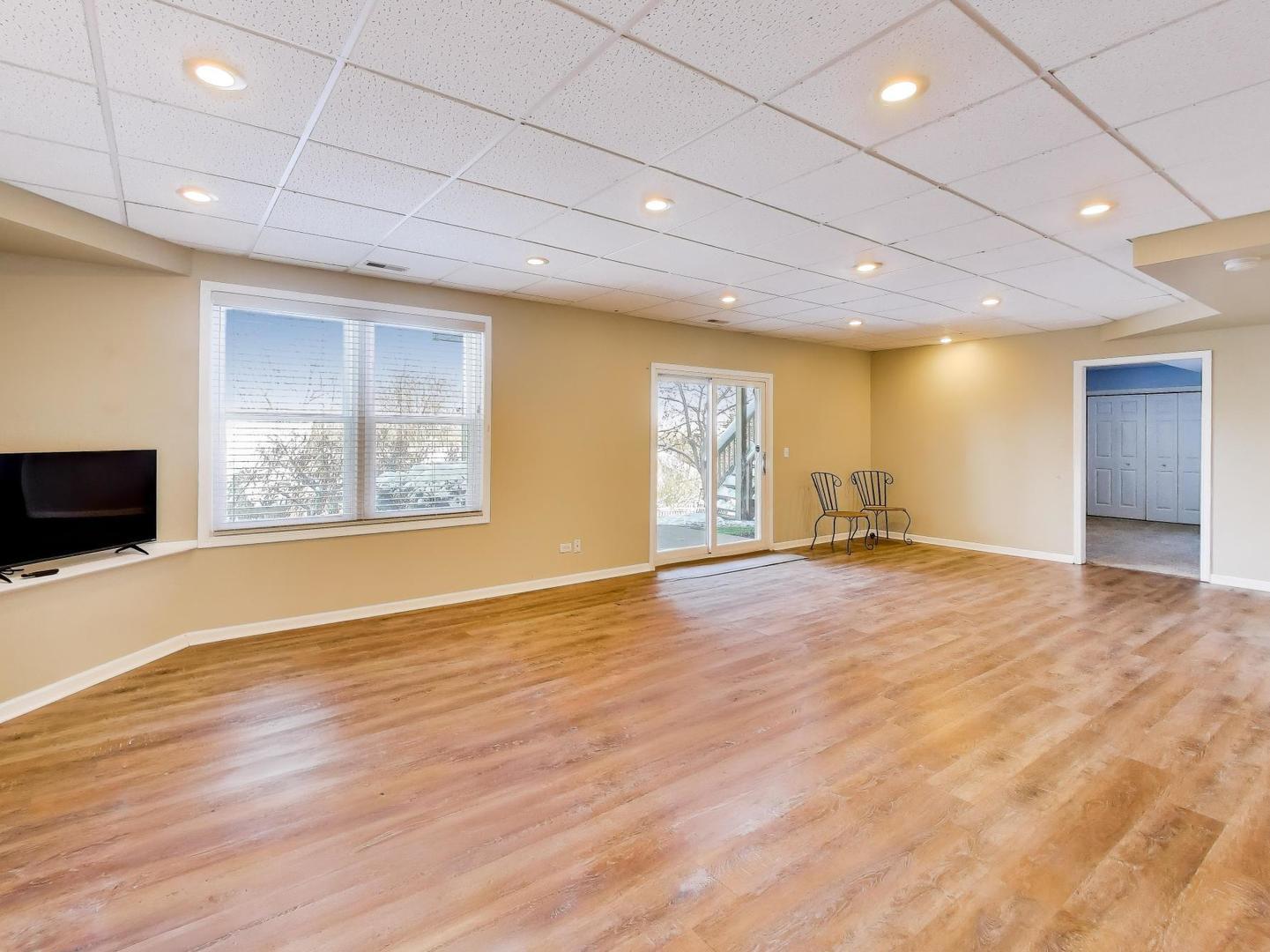 660 Robin Ridge Elgin, IL 60123 - Photo 22 of 29 a view of an empty room with wooden floor and a window