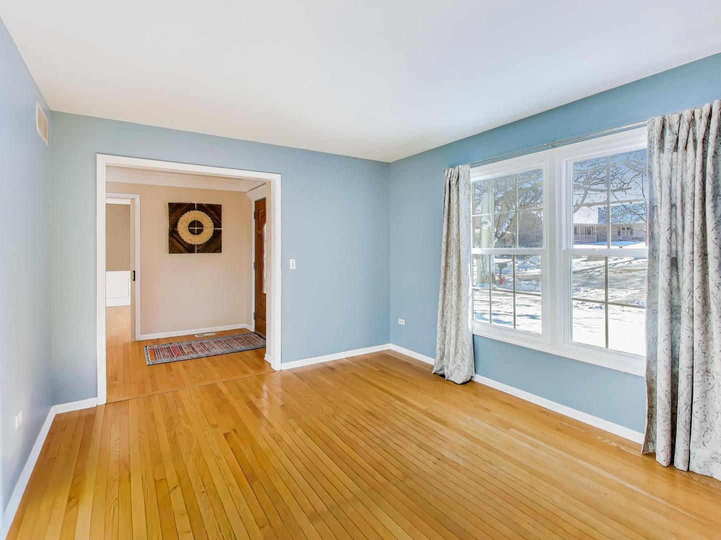660 Robin Ridge Elgin, IL 60123 - Photo 3 of 29 a view of an empty room with wooden floor and a window