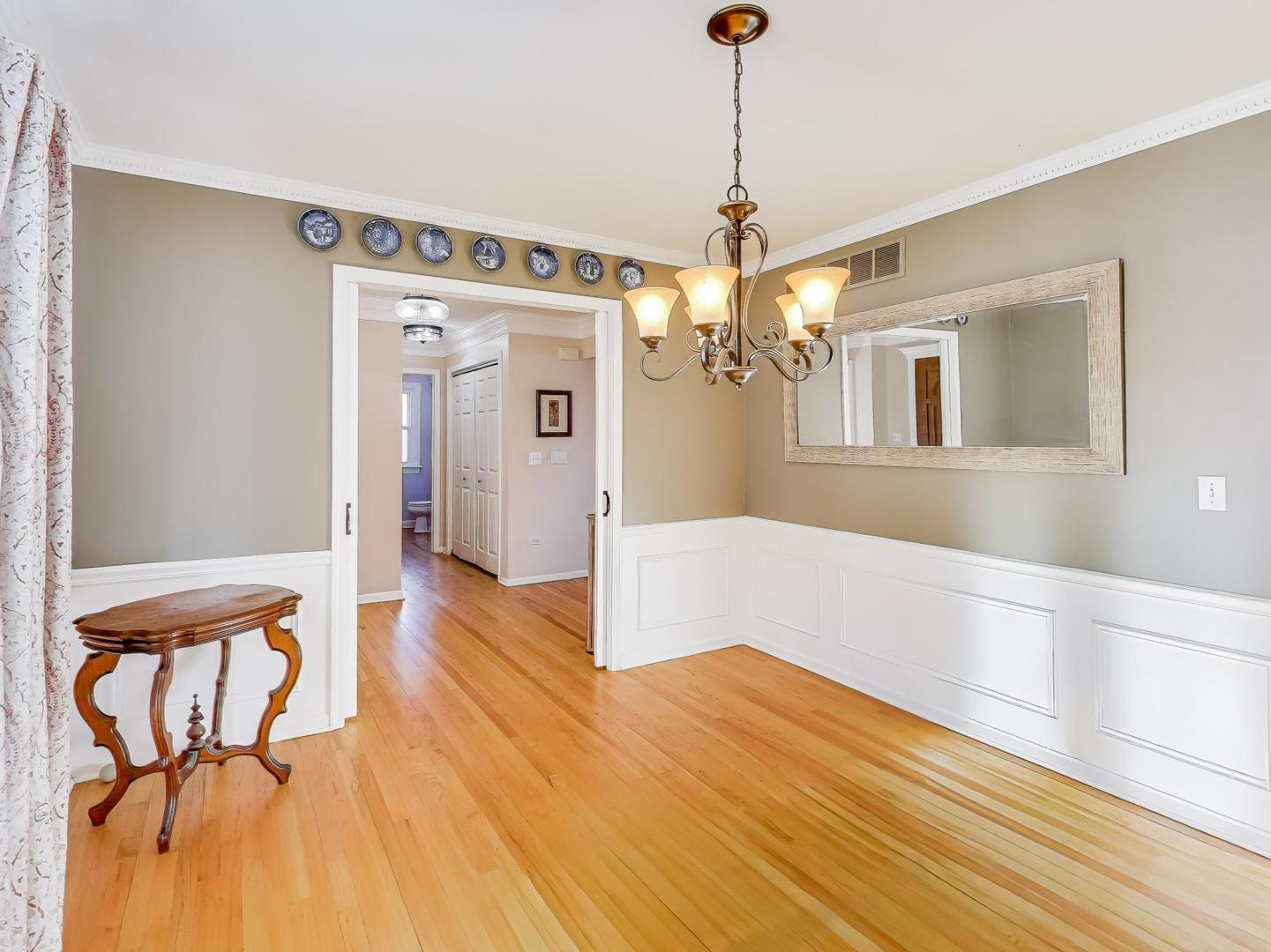 660 Robin Ridge Elgin, IL 60123 - Photo 5 of 29 a view of a hallway with wooden floor and chandelier